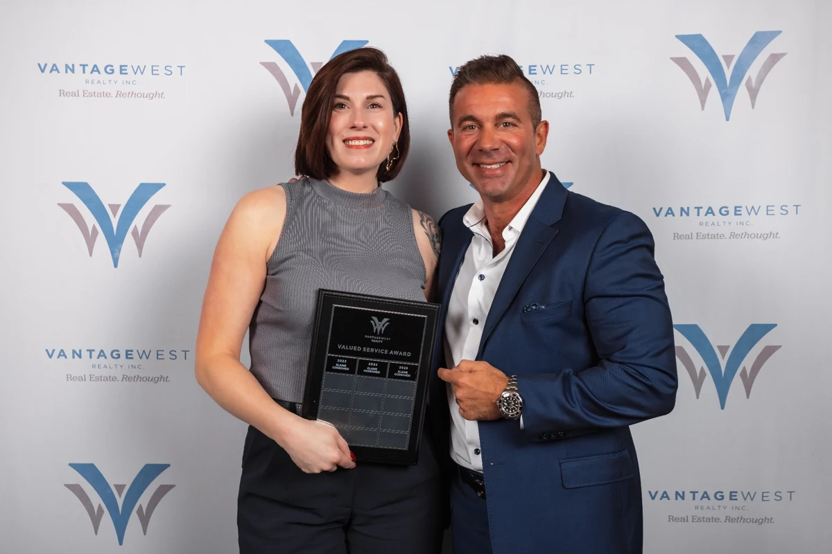 Elaine at a Vantage West awards evening, holding her Valued Service recognition